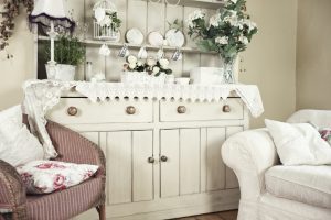 large shabby chic dresser with white sofa and pink chair